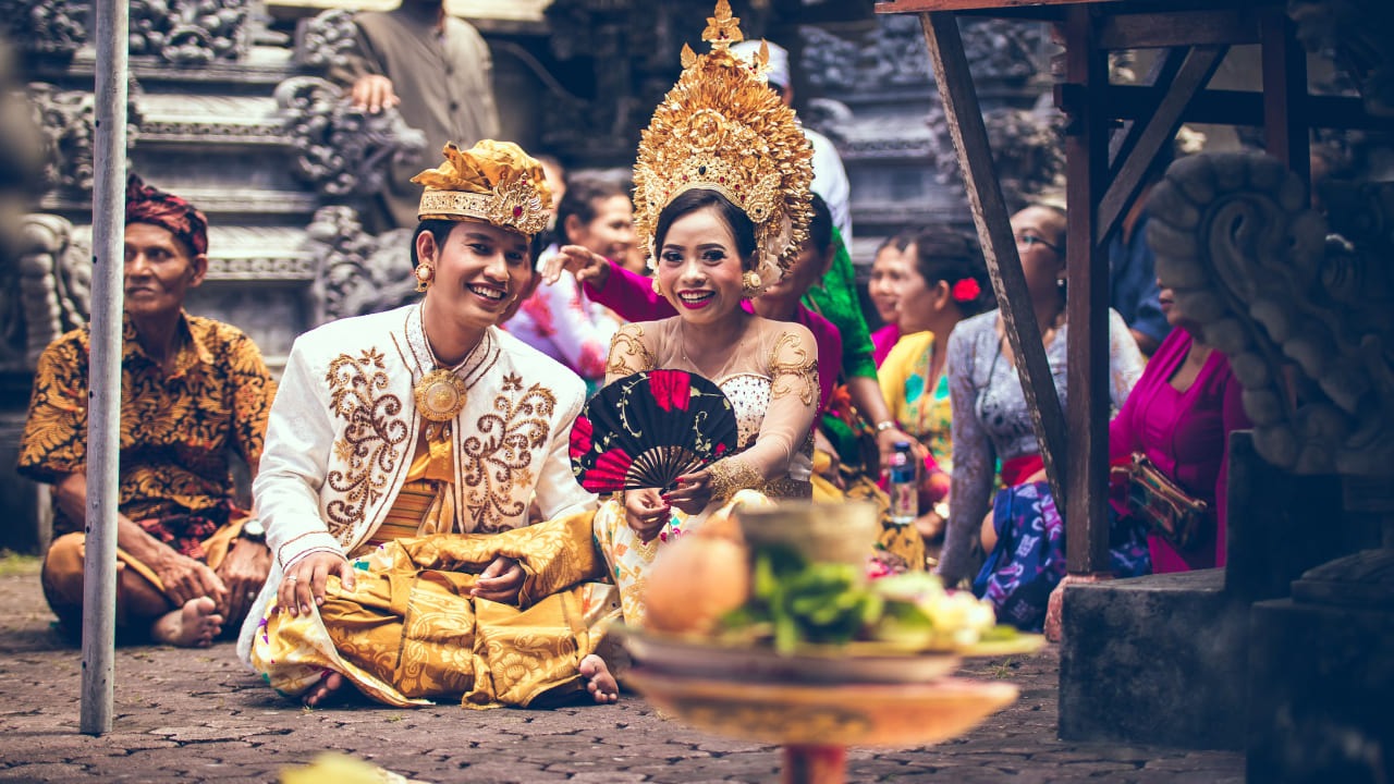 Couple in traditional Balinese wedding attire during a religious ceremony in Bali