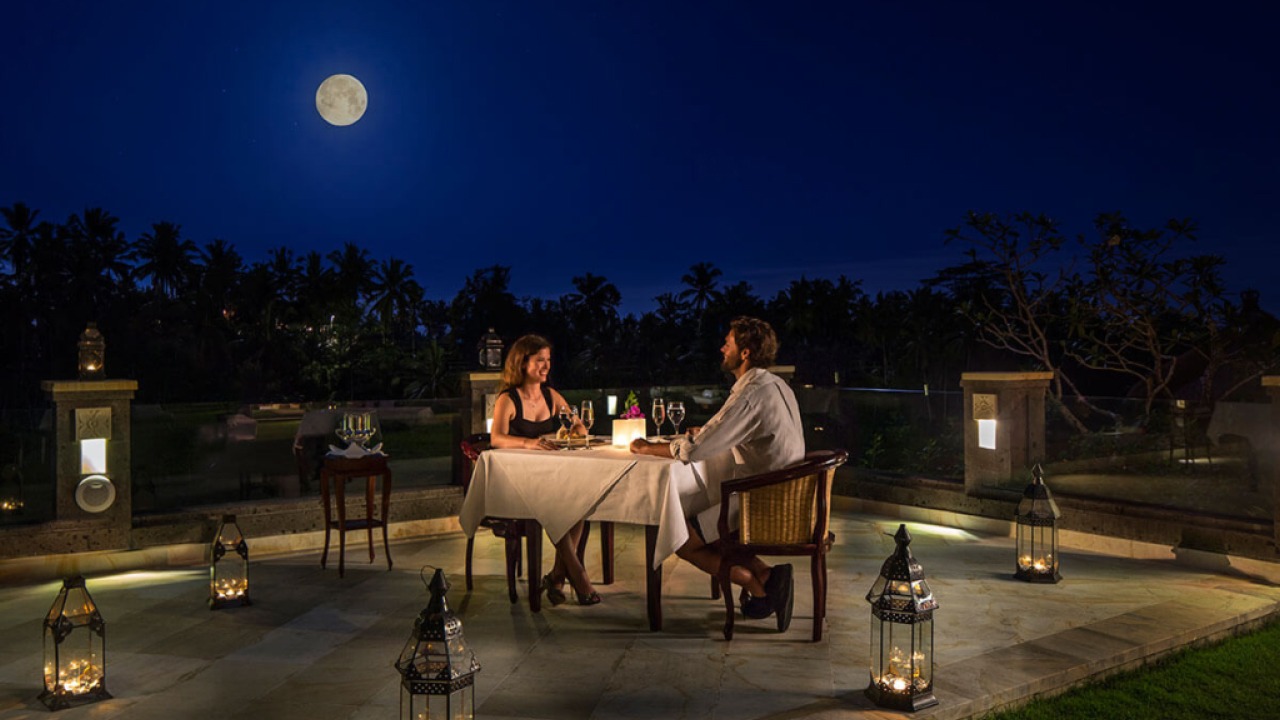Couple enjoying a romantic dinner under the moonlight in Ubud