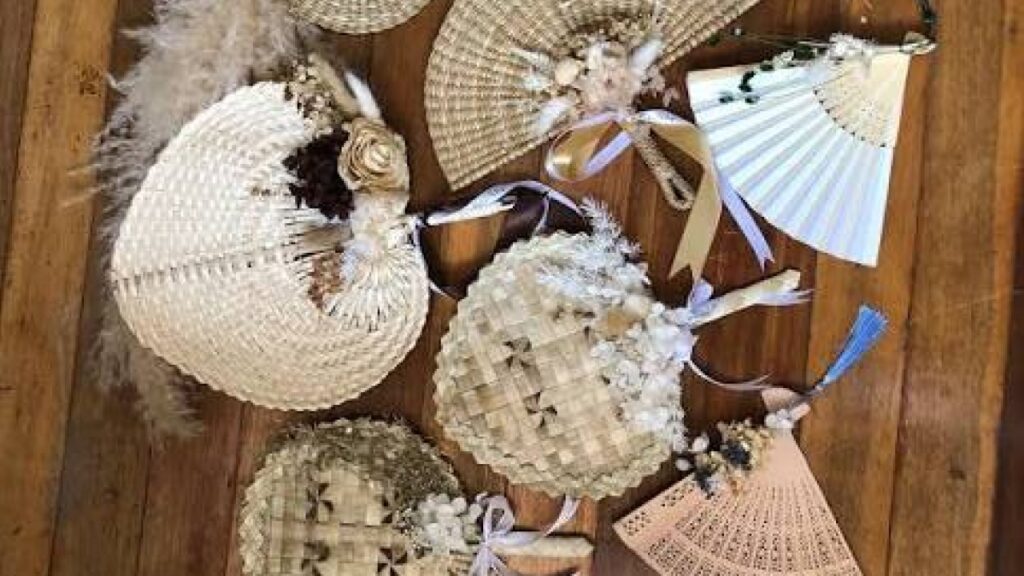 Handwoven fans arranged as wedding favors for an outdoor Bali ceremony