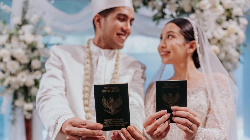Wedding couple holding marriage documents in Bali