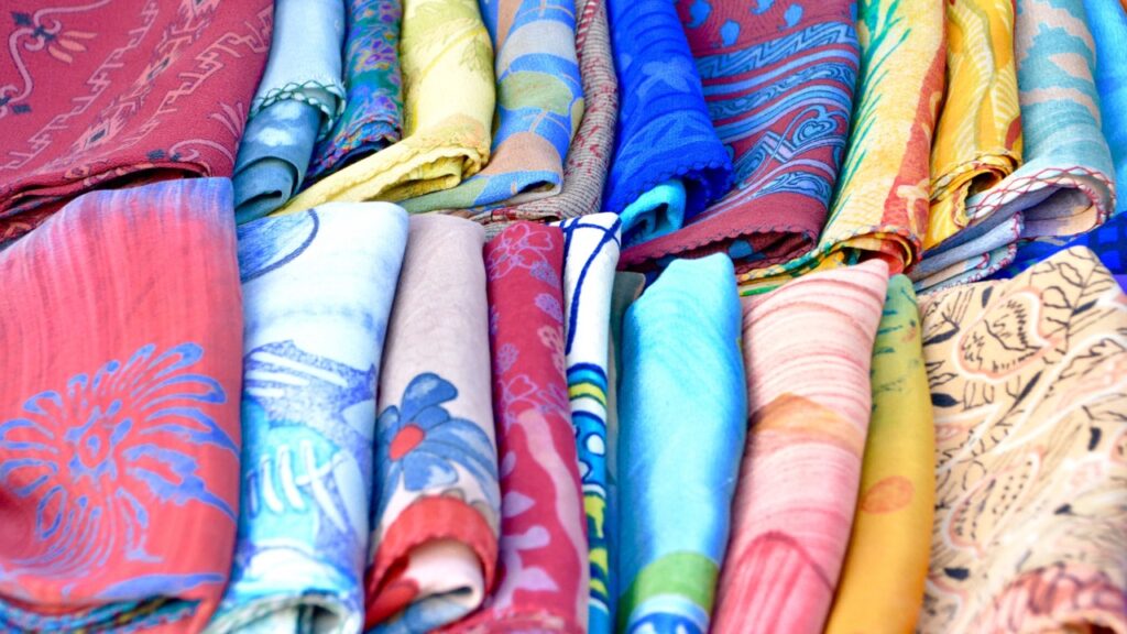 Colorful Balinese sarongs displayed as wedding guest gifts