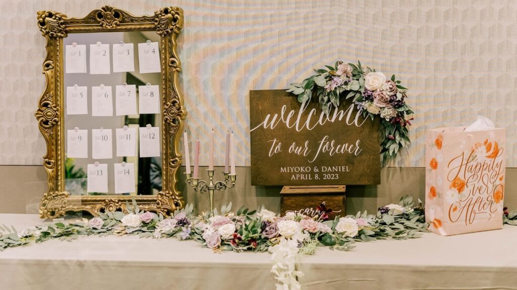 Wedding welcome table displaying guest cards, favors, and floral decorations